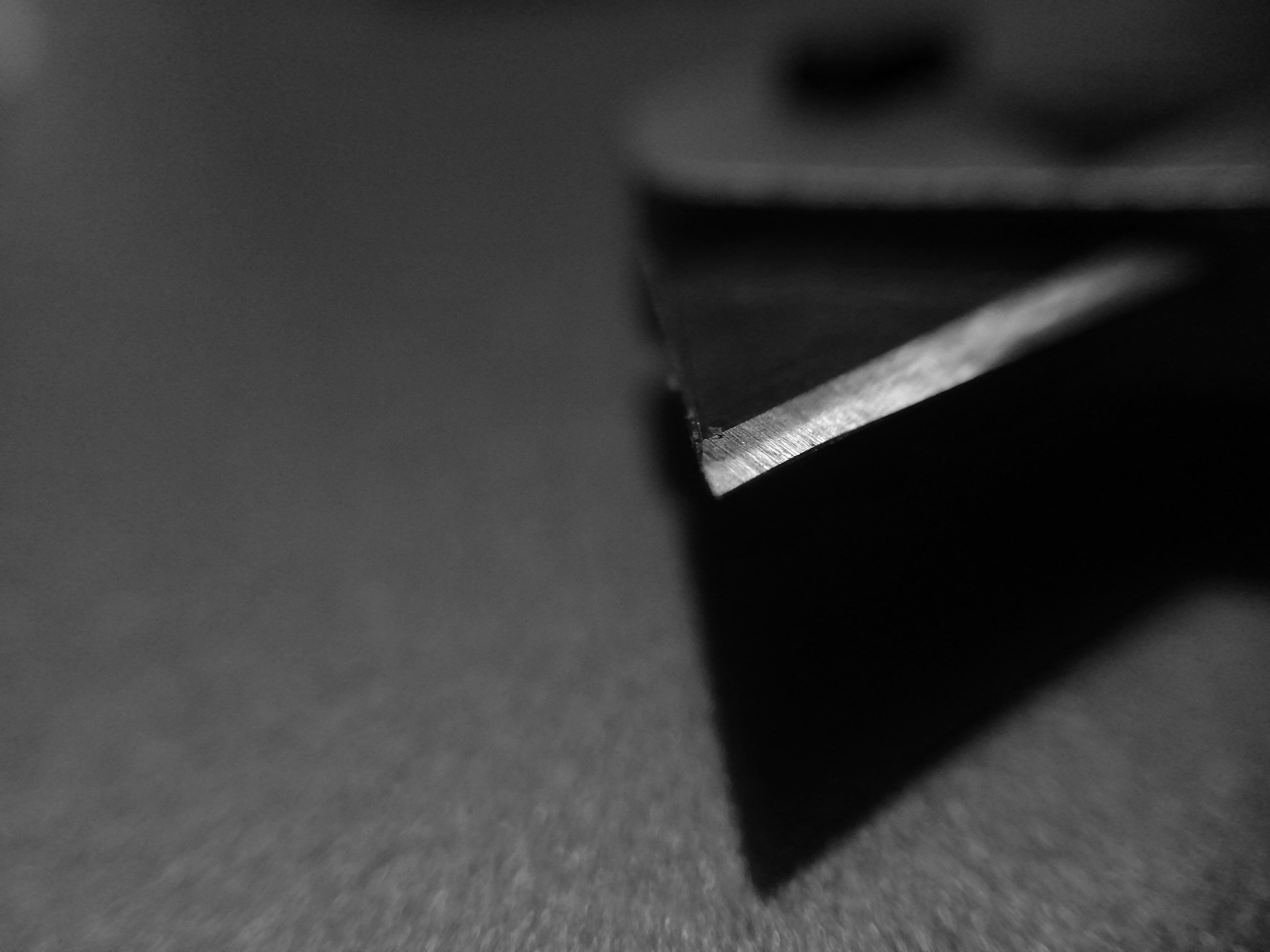 This is a black and white macro shot of a box-cutters blade