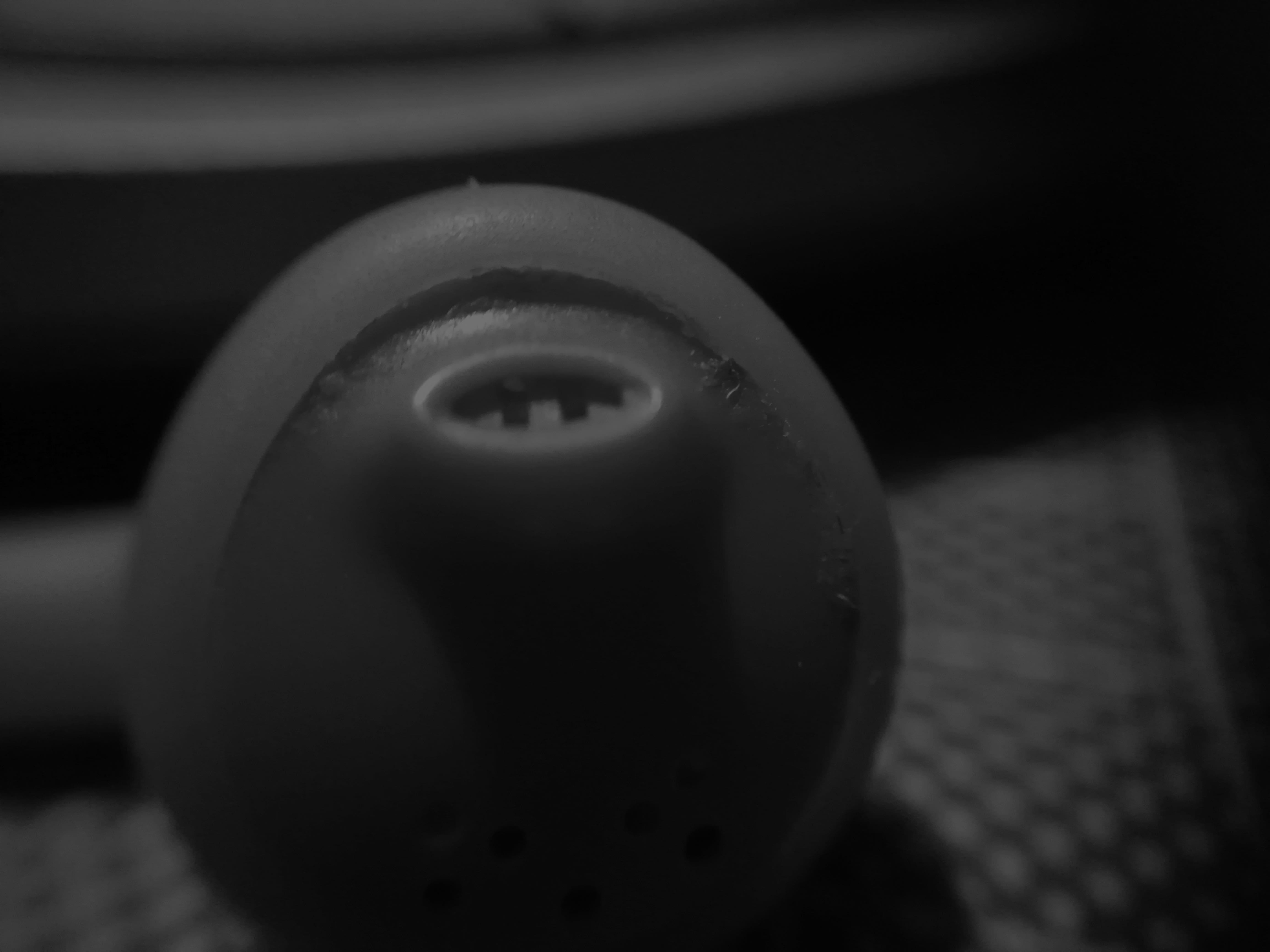 This as a black and white macro shot of an earphone