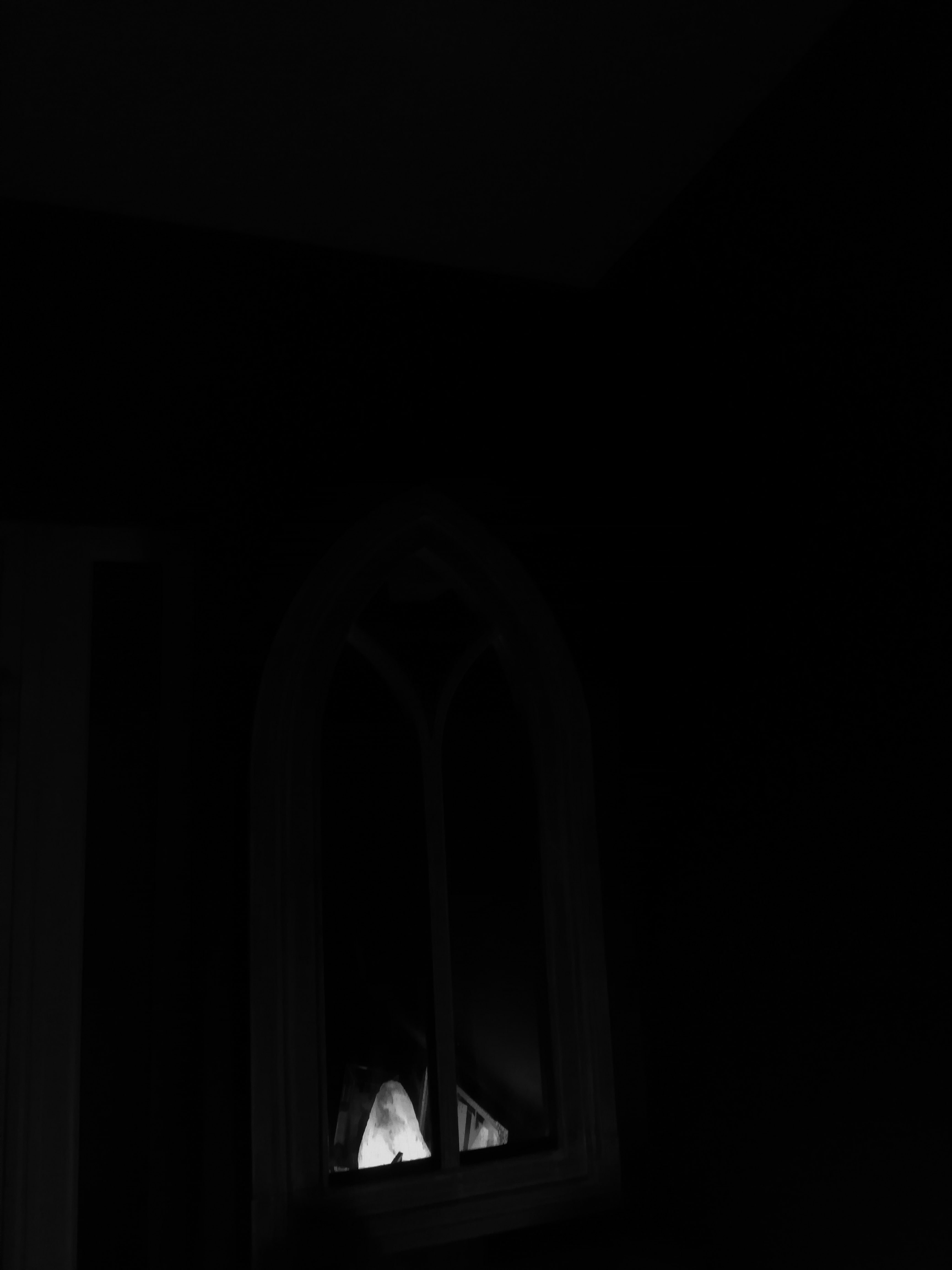 This is a black and white shot of a salt lamp reflecting off of a wall mirror